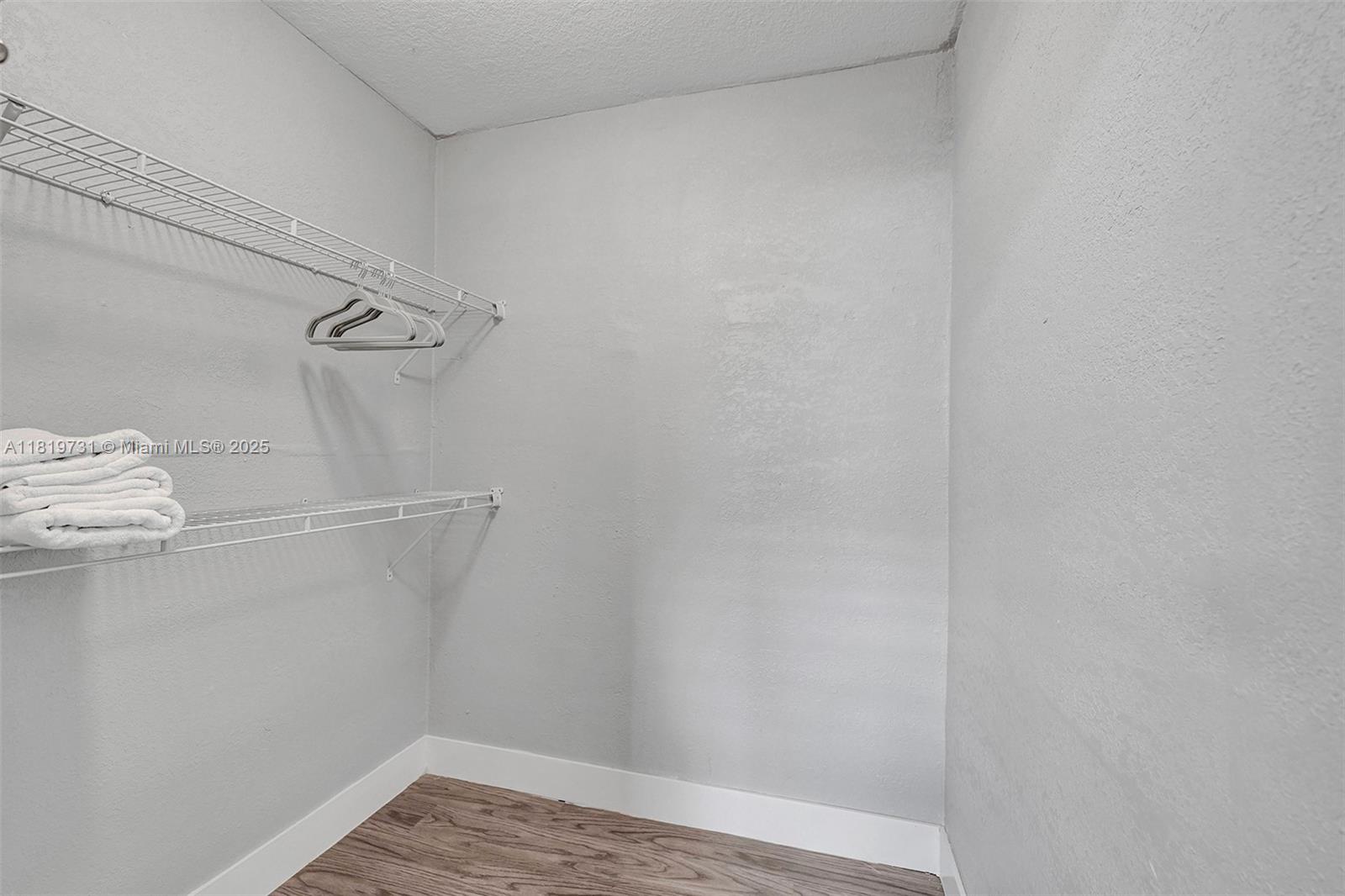 1324 Northeast 151st Street, Unit 1324 Miami, FL 33162 - Photo 12 of 23 a view of a room with racks on the wall