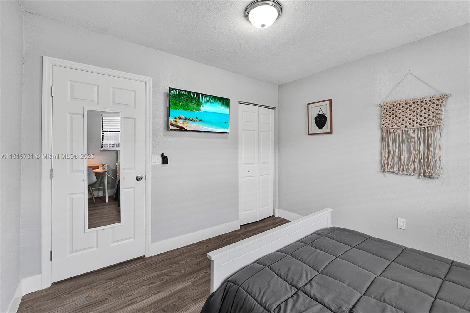 1324 Northeast 151st Street, Unit 1324 Miami, FL 33162 - Photo 13 of 23 a view of a livingroom with wooden floor and closet
