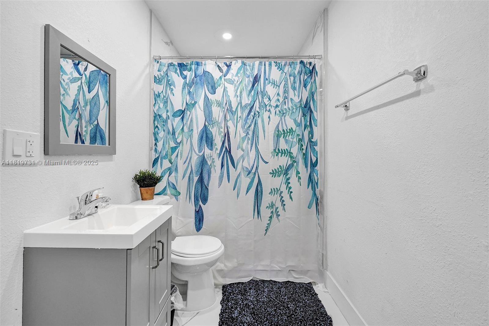 1324 Northeast 151st Street, Unit 1324 Miami, FL 33162 - Photo 14 of 23 a bathroom with a sink toilet and shower