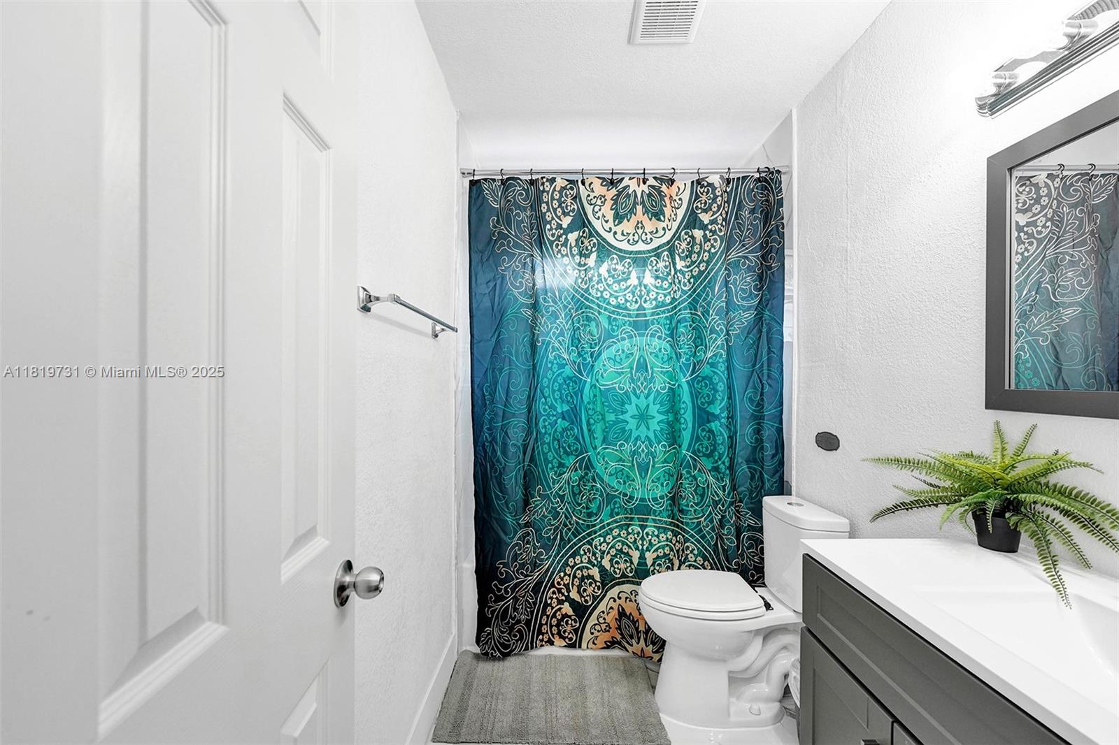 1324 Northeast 151st Street, Unit 1324 Miami, FL 33162 - Photo 15 of 23 a bathroom with a toilet a sink and tub