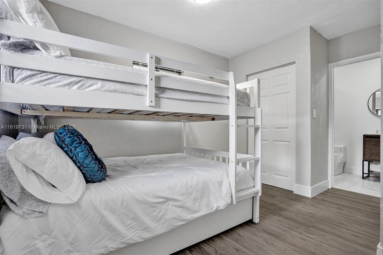 1324 Northeast 151st Street, Unit 1324 Miami, FL 33162 - Photo 17 of 23 a room with a bed and wooden floor