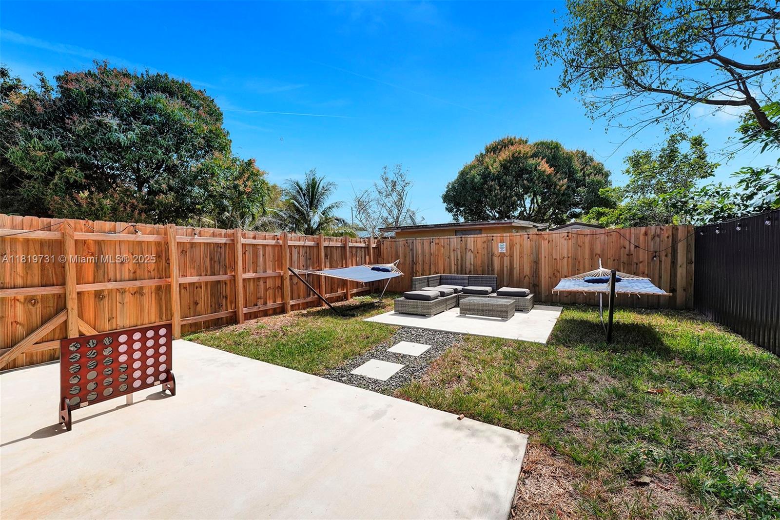 1324 Northeast 151st Street, Unit 1324 Miami, FL 33162 - Photo 21 of 23 a view of a garden with wooden fence