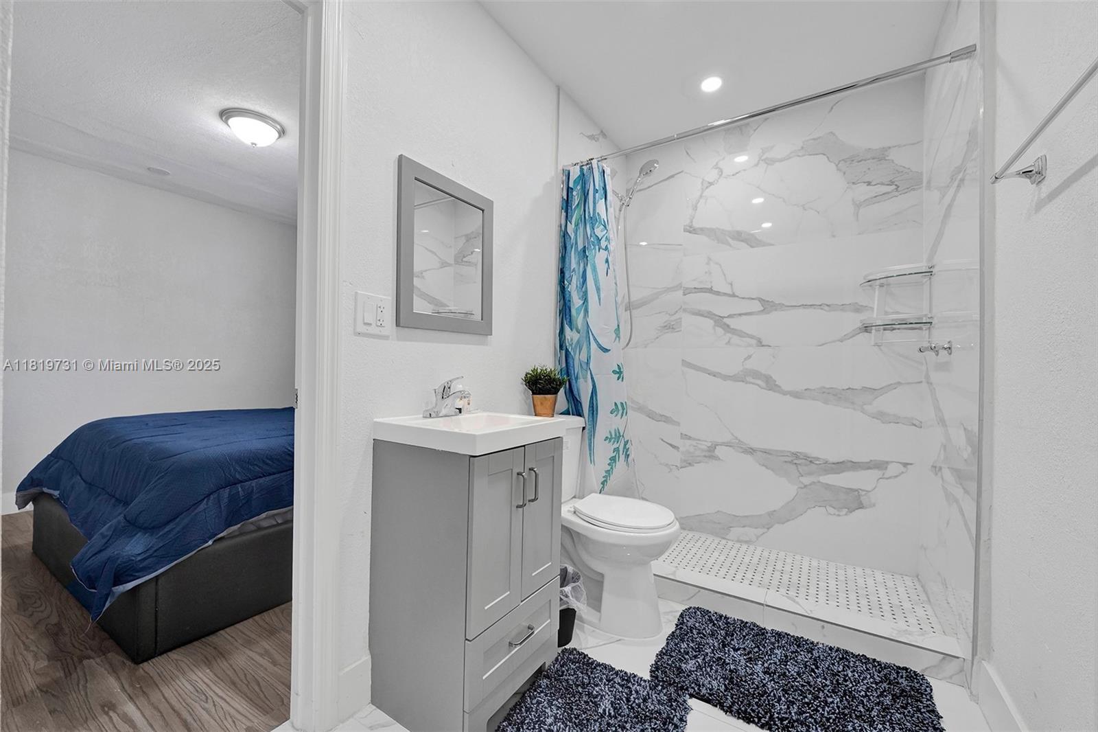 1324 Northeast 151st Street, Unit 1324 Miami, FL 33162 - Photo 10 of 23 a bathroom with a sink toilet a mirror and shower