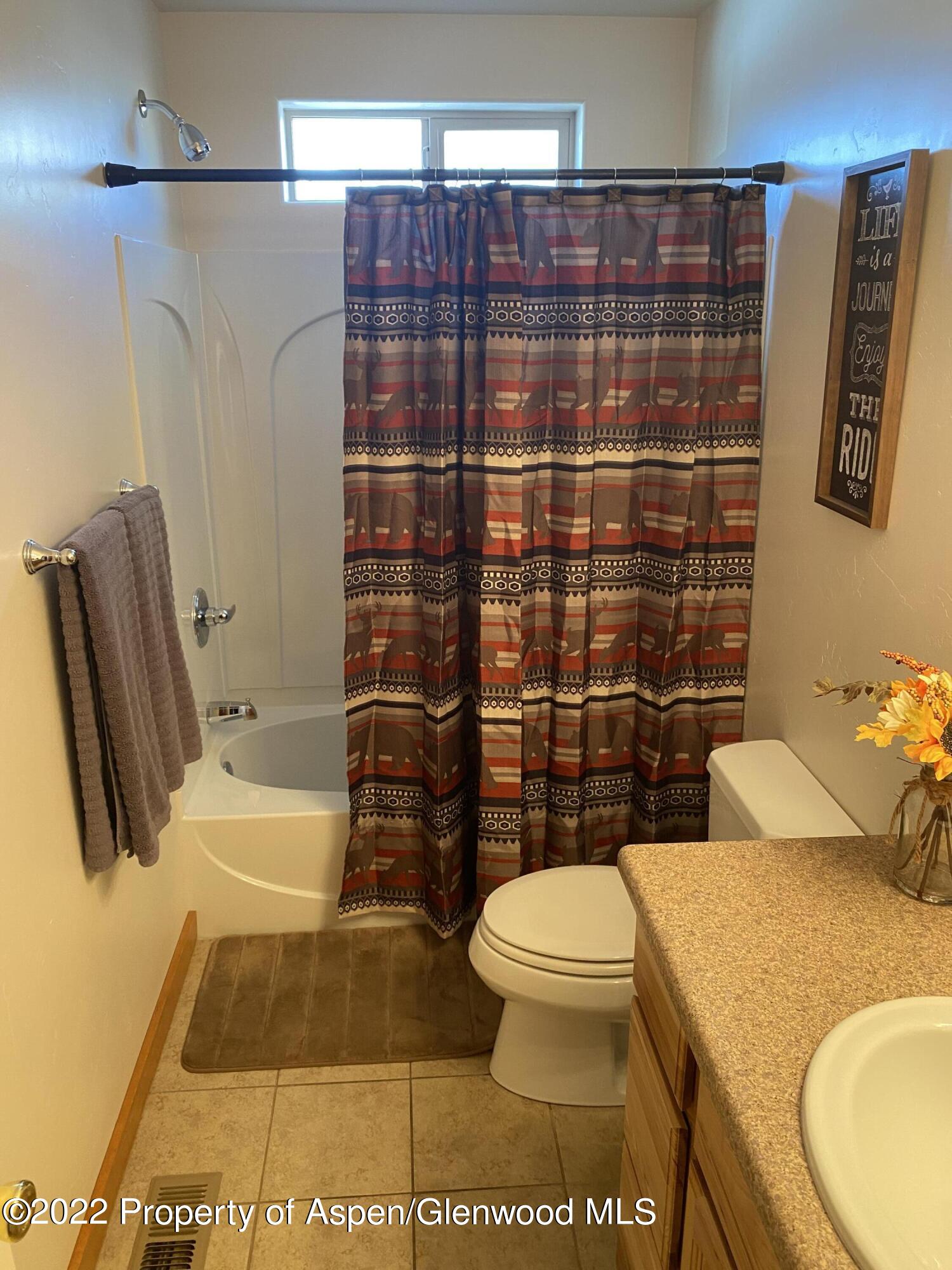 858 East 17th Street Rifle, CO 81650 - Photo 7 of 20 a bathroom with a toilet and shower
