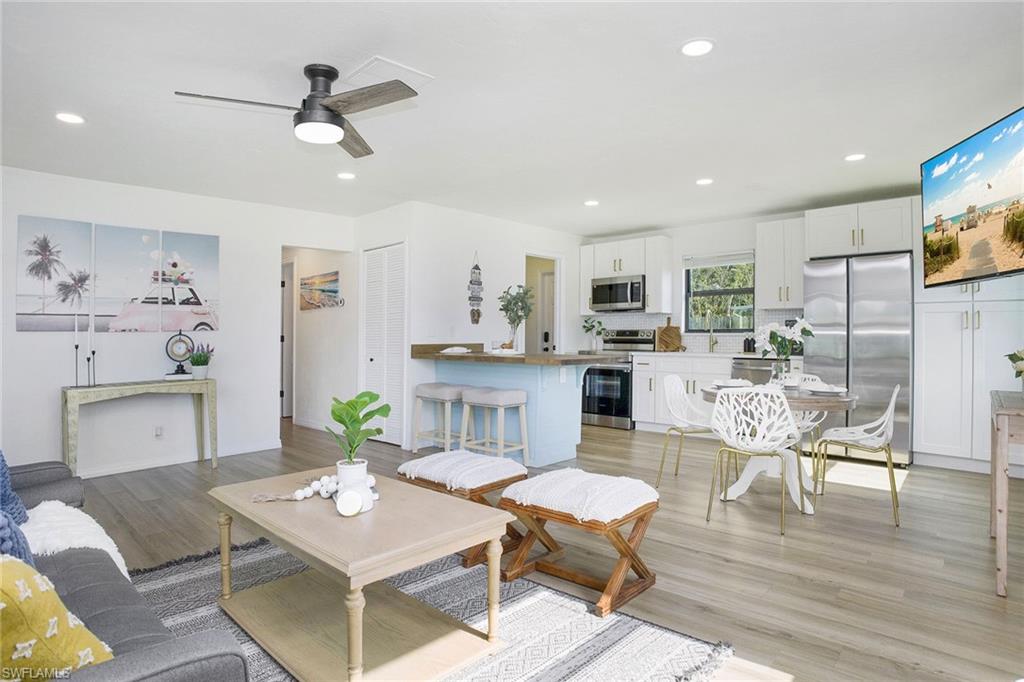 a living room with furniture and kitchen view