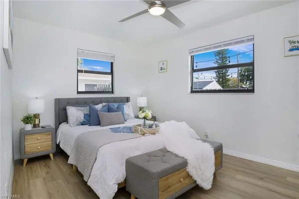 a bedroom with a bed and a painting on the wall