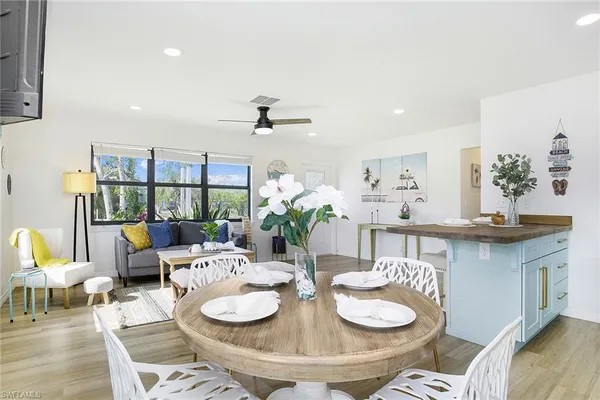 a living room with granite countertop furniture a dining table and chairs with potted plants