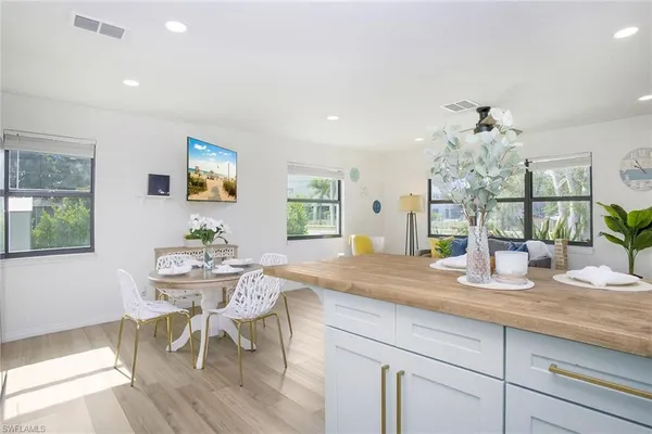 a kitchen with granite countertop white cabinets and dining table