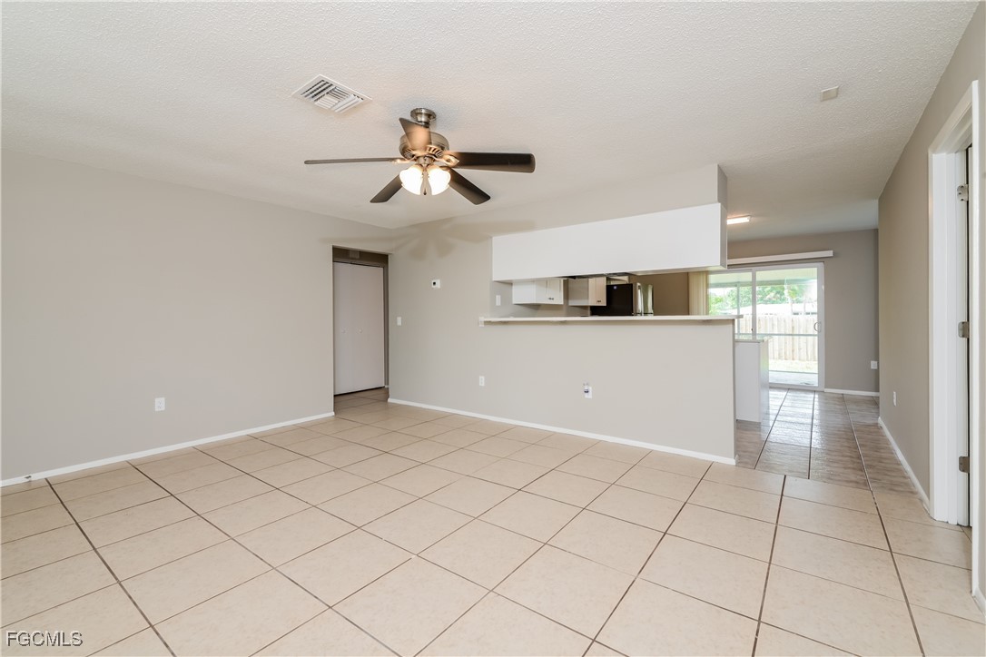 3286 Papaya Road Venice, FL 34293 - Photo 2 of 16 a view of a livingroom with a ceiling fan a kitchen and a window