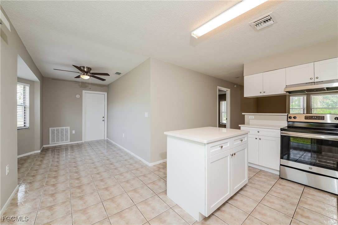 3286 Papaya Road Venice, FL 34293 - Photo 5 of 16 a kitchen with a stove top oven and cabinets