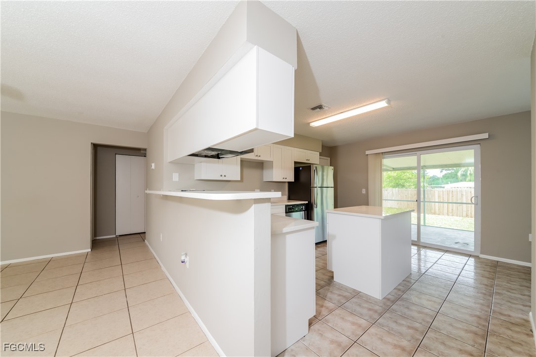 3286 Papaya Road Venice, FL 34293 - Photo 6 of 16 a utility room with cabinets washer and dryer