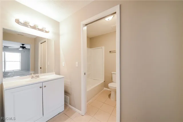 a bathroom with a granite countertop sink two mirror and a