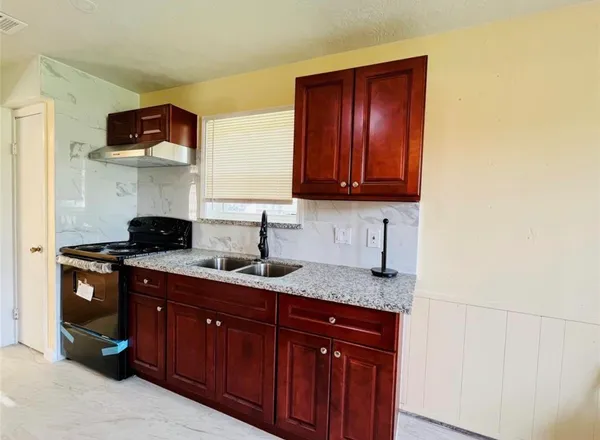 a kitchen with granite countertop cabinets and a sink