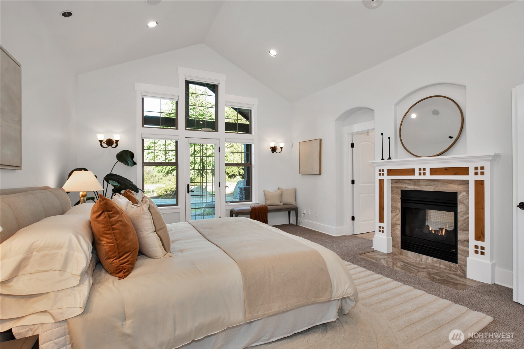 7732 Rich Road Southeast Olympia, WA 98501 - Photo 15 of 40 a spacious bedroom with a large bed and a fireplace