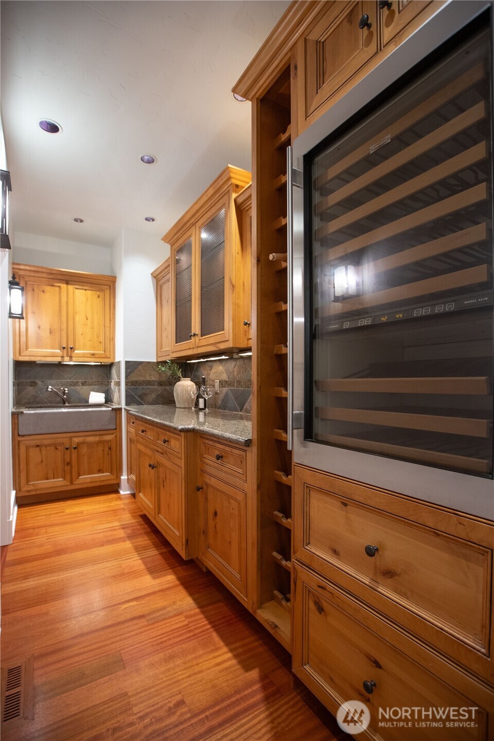 7732 Rich Road Southeast Olympia, WA 98501 - Photo 23 of 40 a kitchen with granite countertop wooden cabinets and white appliances