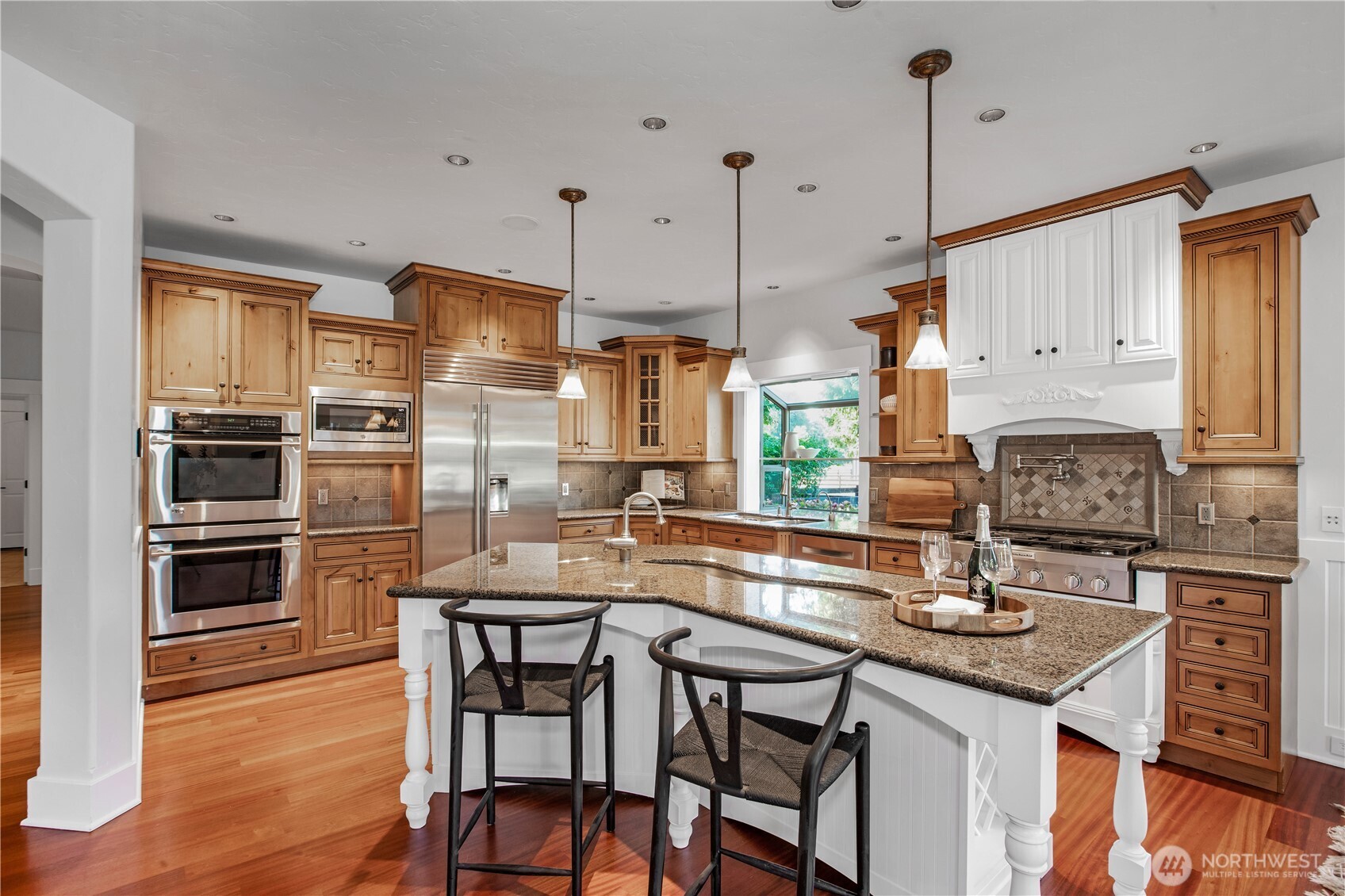 7732 Rich Road Southeast Olympia, WA 98501 - Photo 5 of 40 a kitchen with stainless steel appliances kitchen island granite countertop a table chairs and a stove