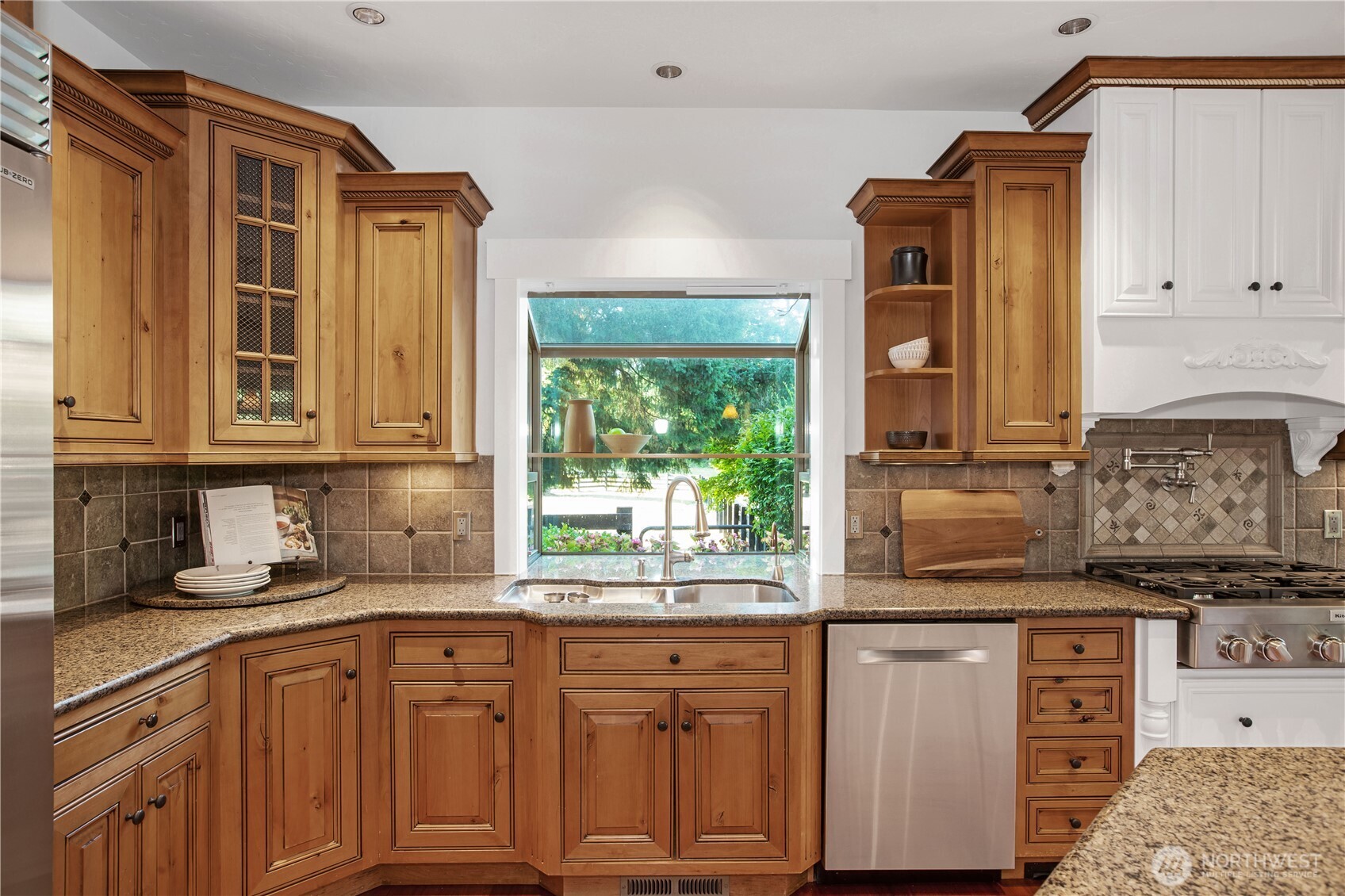 7732 Rich Road Southeast Olympia, WA 98501 - Photo 6 of 40 a kitchen with granite countertop a sink window and cabinets