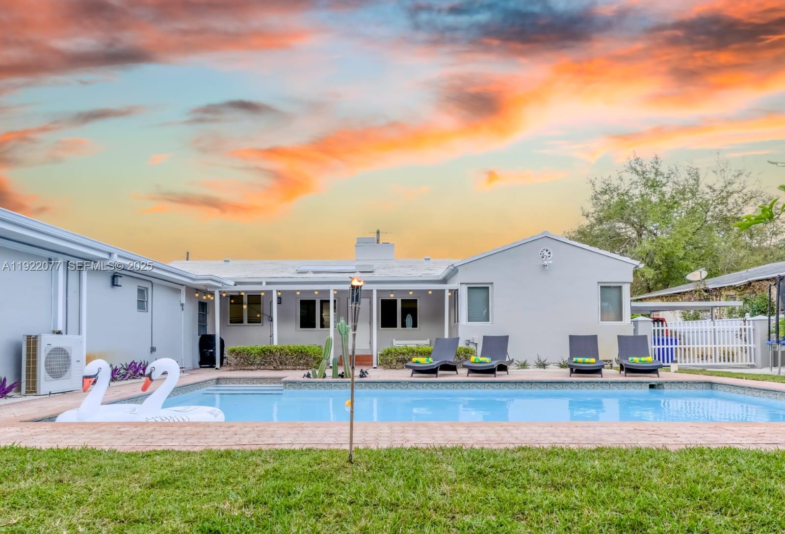 1230 Southwest 22nd Terrace Miami, FL 33145 - Photo 12 of 35 a front view of a house with a yard table and chairs