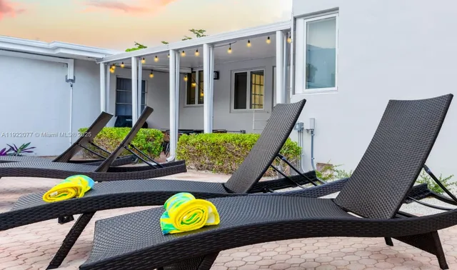 a view of a chairs and table in a patio
