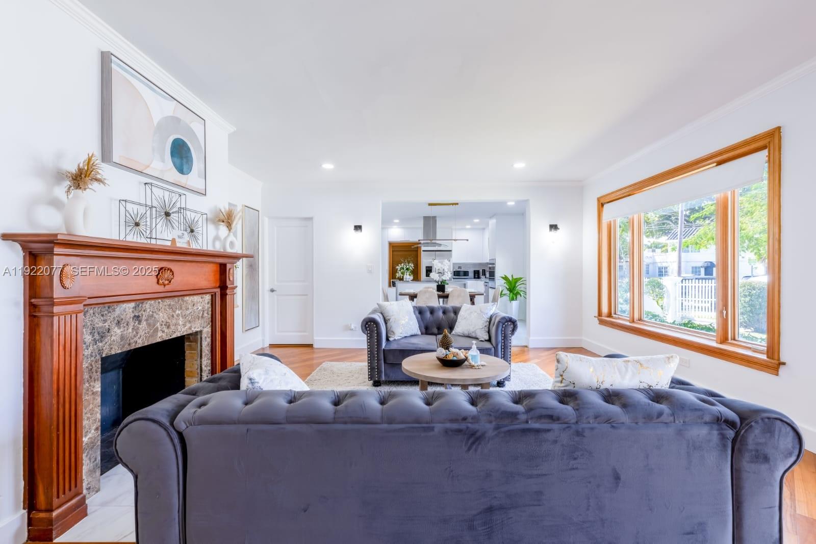 1230 Southwest 22nd Terrace Miami, FL 33145 - Photo 14 of 35 a living room with furniture a fireplace and a large window