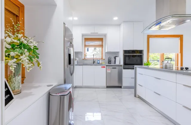 a kitchen with a sink and a stove top oven