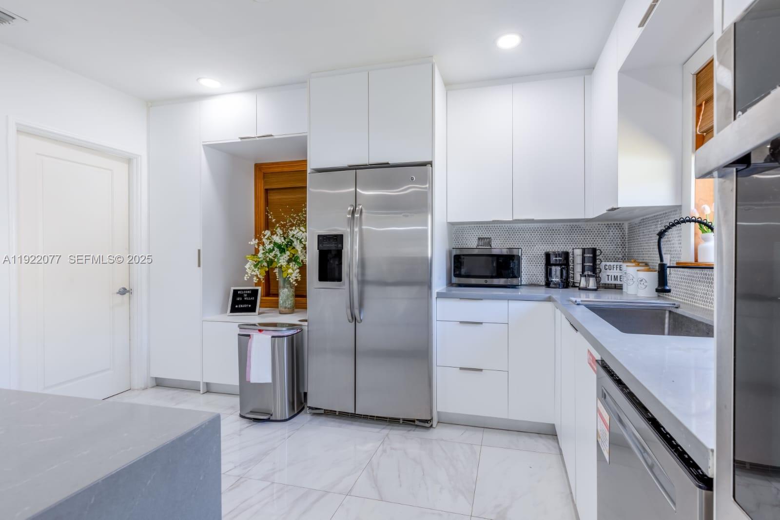 1230 Southwest 22nd Terrace Miami, FL 33145 - Photo 20 of 35 a kitchen with a refrigerator sink and cabinets