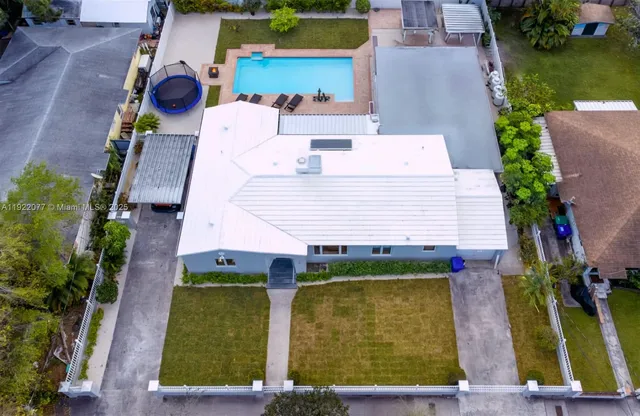 an aerial view of residential house with outdoor space and swimming pool