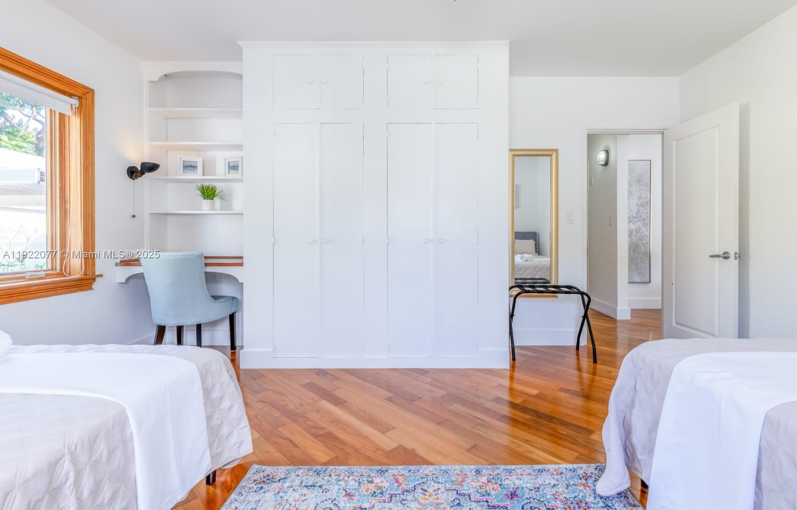 1230 Southwest 22nd Terrace Miami, FL 33145 - Photo 27 of 35 a bedroom with a bed and wooden floor