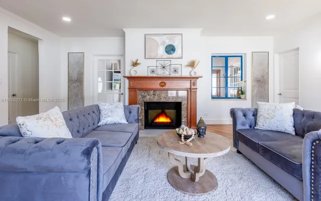 a living room with furniture and a fireplace