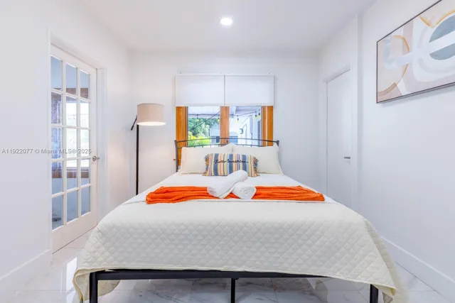 a bedroom with a bed and window