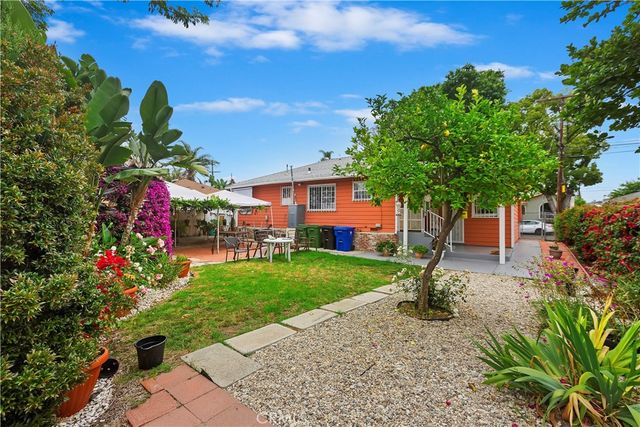 a front view of a house with a yard and fountain