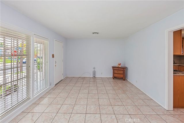 a view of a livingroom with an empty space and a window