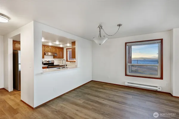 a view of a hallway with wooden floor and a living room