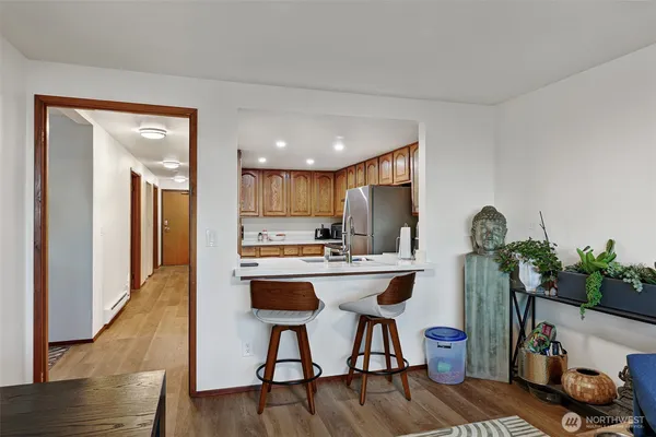 a open kitchen with stainless steel appliances granite countertop a refrigerator and a stove top oven