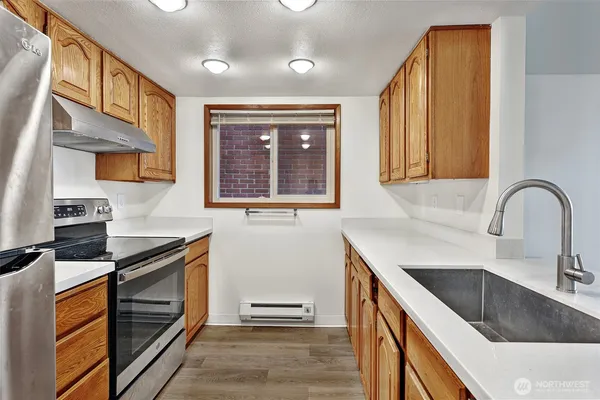 a kitchen with granite countertop a stove and a sink