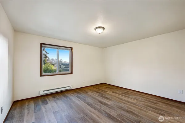 a view of a room with wooden floor and window