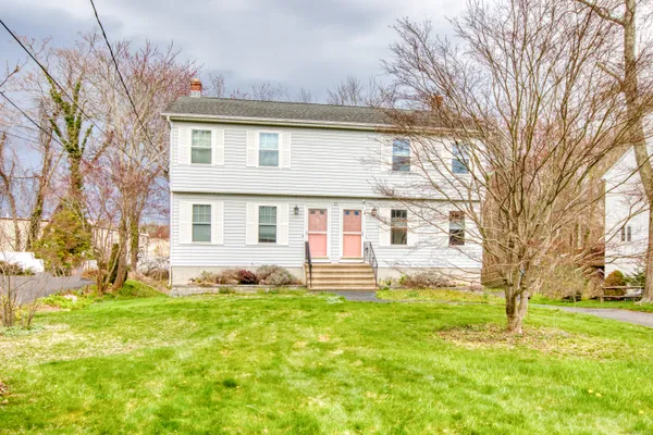 a front view of house with yard and green space
