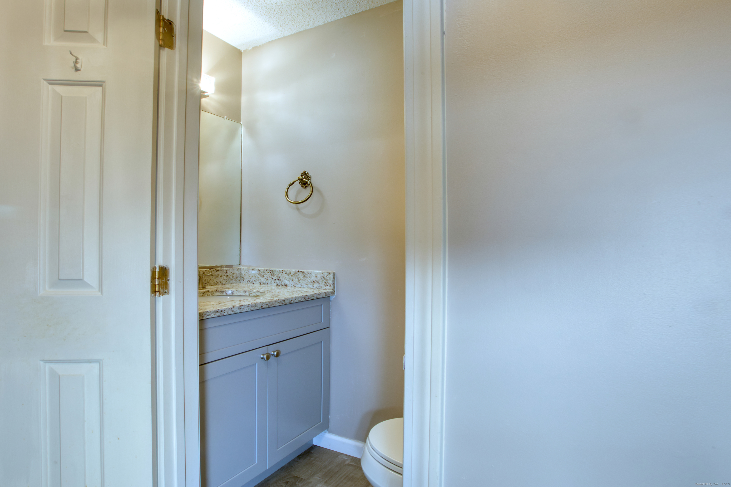 12 Clancy Road, Unit A Branford, CT 06405 - Photo 13 of 31 a bathroom with a granite countertop sink a toilet and shower