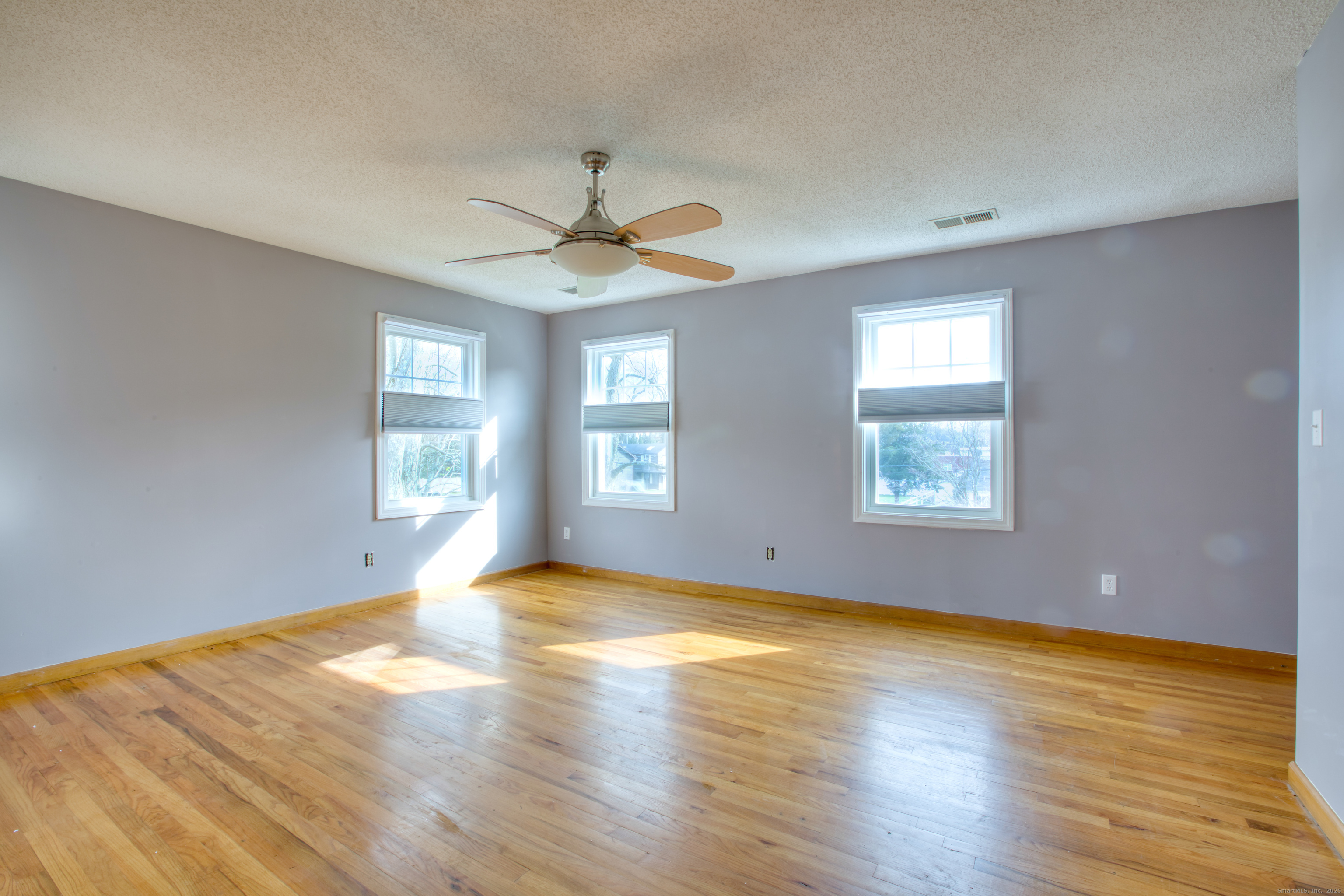 12 Clancy Road, Unit A Branford, CT 06405 - Photo 18 of 31 a view of an empty room with window and wooden floor