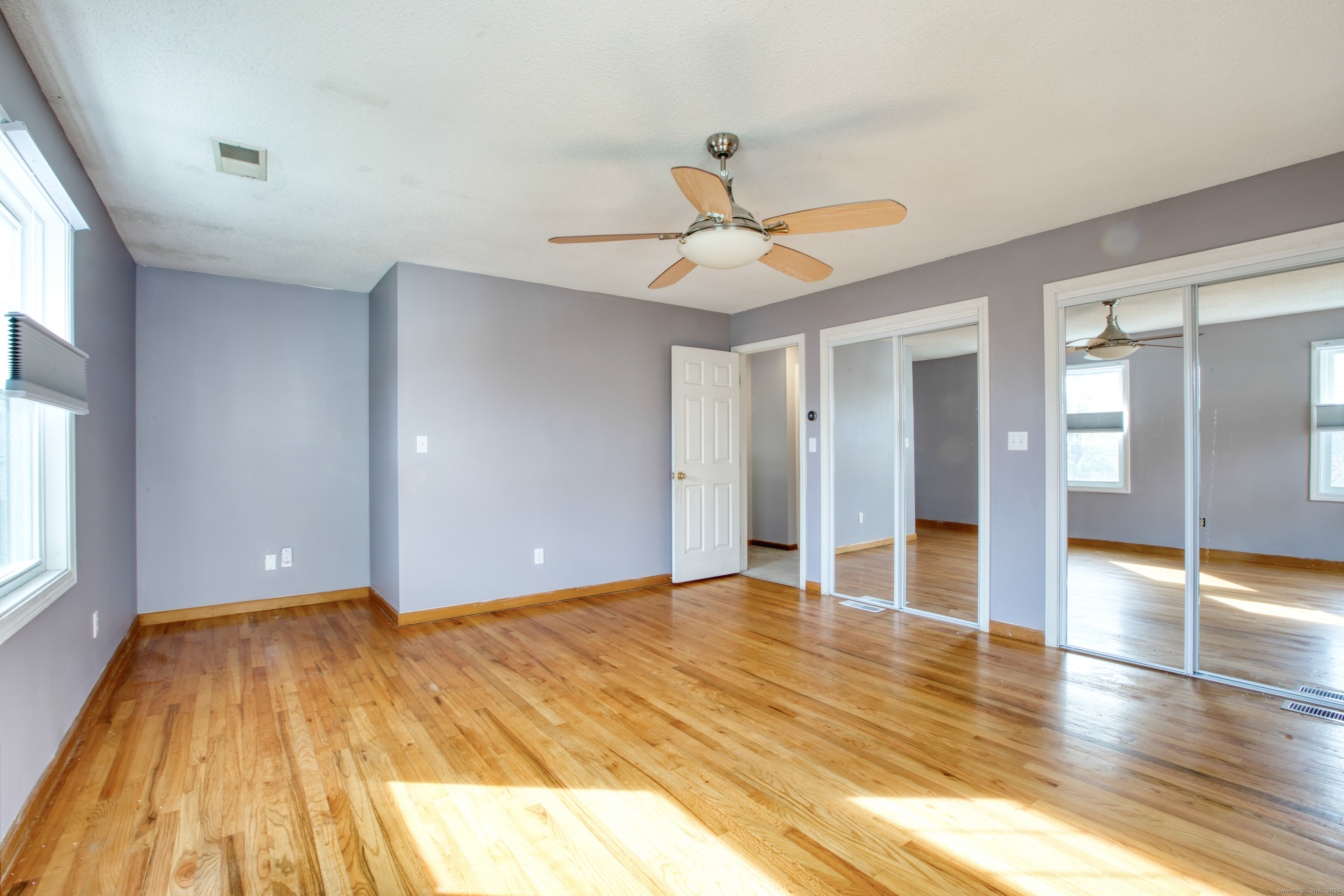 12 Clancy Road, Unit A Branford, CT 06405 - Photo 22 of 31 a view of an empty room with window and wooden floor