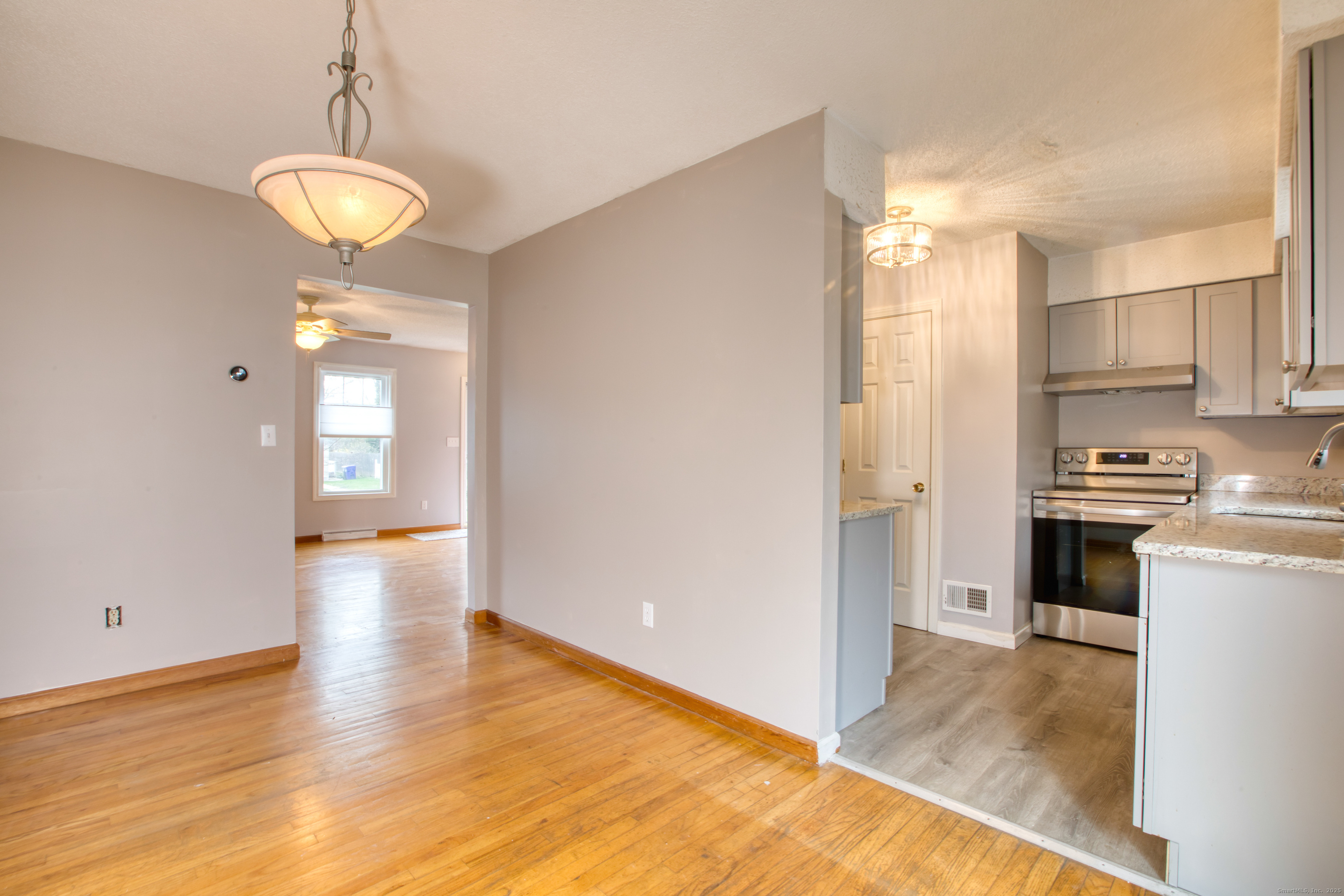 12 Clancy Road, Unit A Branford, CT 06405 - Photo 4 of 31 a view of a kitchen with a stove cabinets and wooden floor