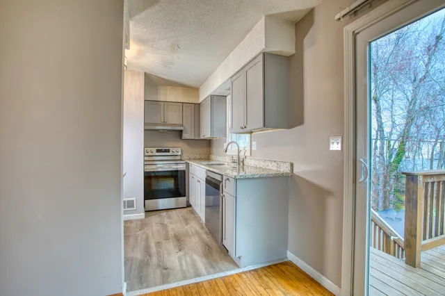 a kitchen with a refrigerator and a stove top oven
