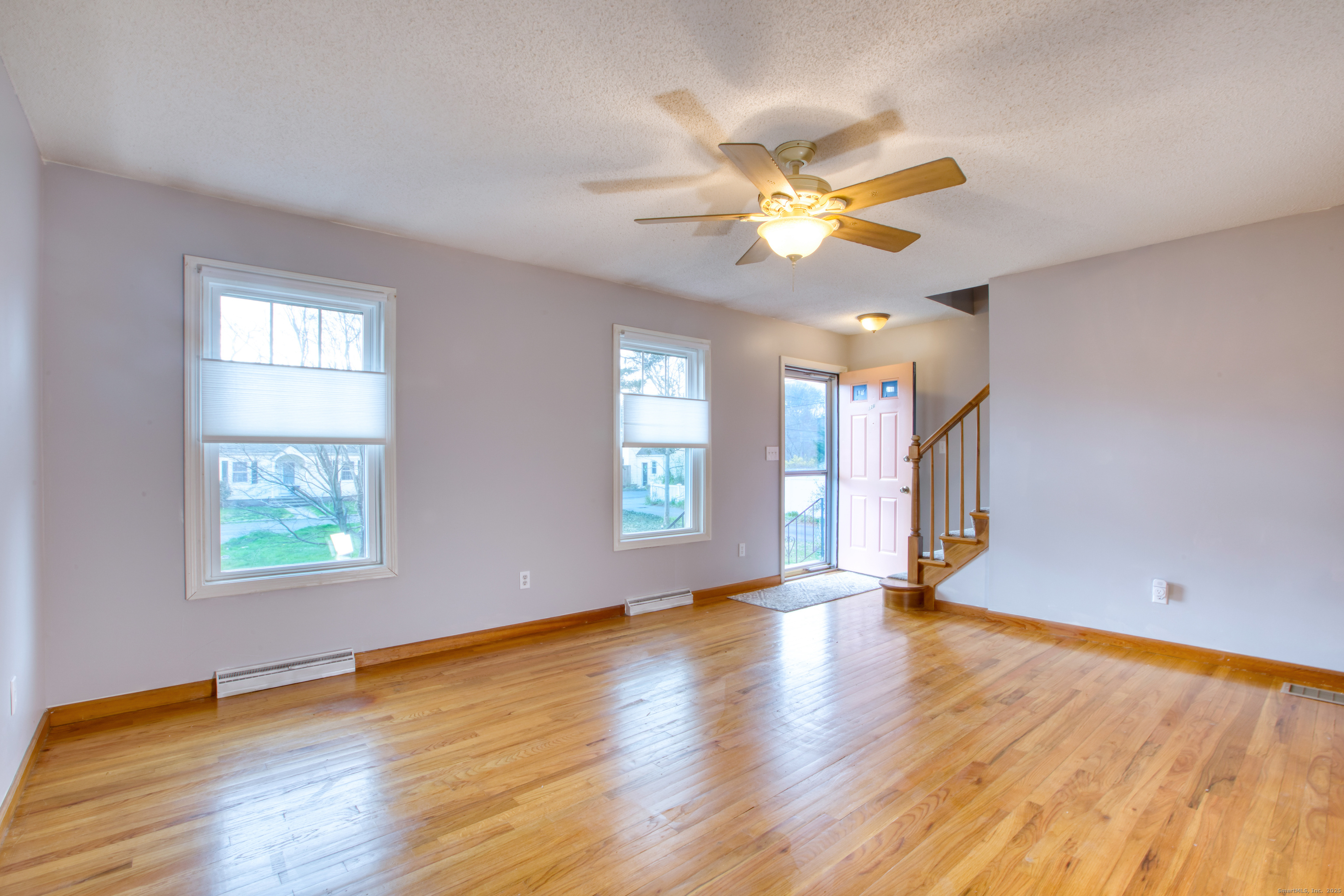 12 Clancy Road, Unit A Branford, CT 06405 - Photo 9 of 31 a view of an empty room with window and wooden floor