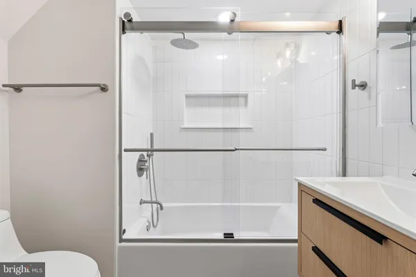 a bathroom with a shower and a sink