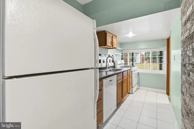 a kitchen with a refrigerator and a sink