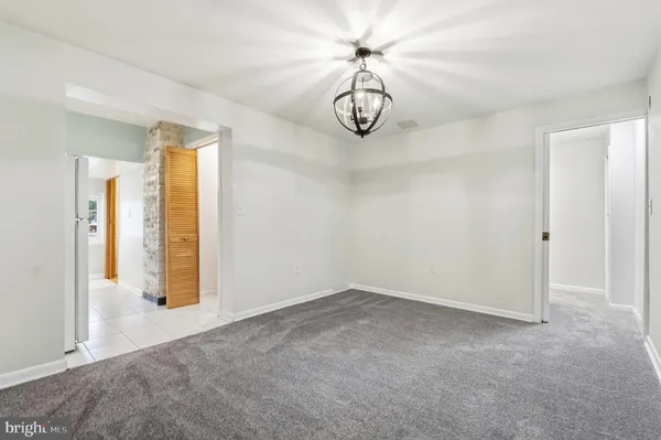 an empty room with a empty space and windows