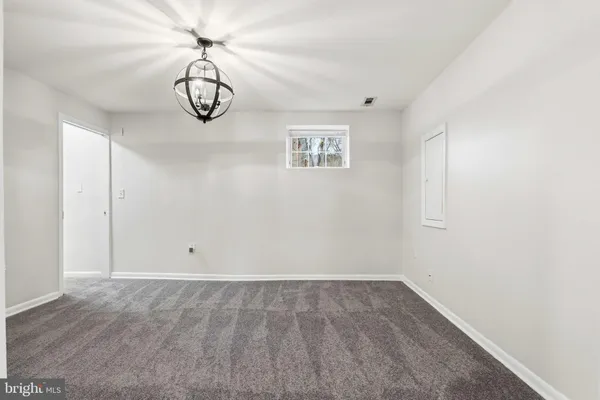 a view of a room with wooden floor and cabinets