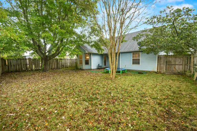 a front view of house with a garden