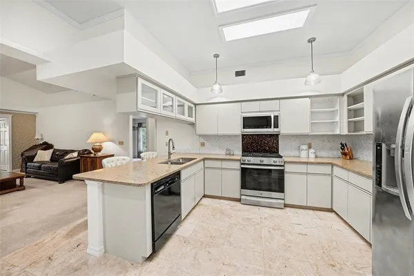 a kitchen with a sink stove and refrigerator