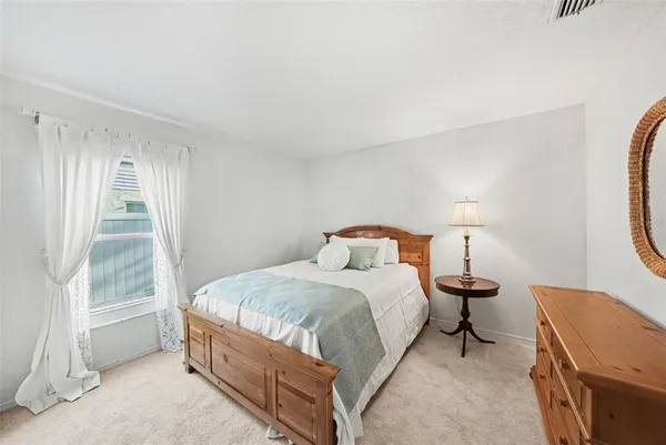 a bed room with a bed and a lamp